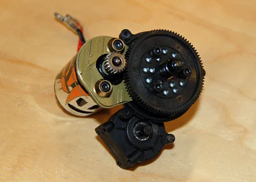 Axial motor pinion meshed with transmission spur gear