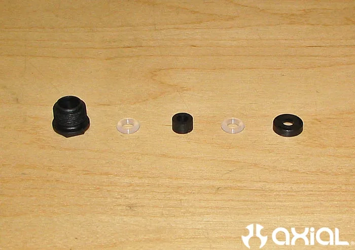 Shock cartridge components laid out in order on a workbench