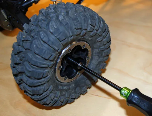 Crawler wheel and axle on a workshop bench during service