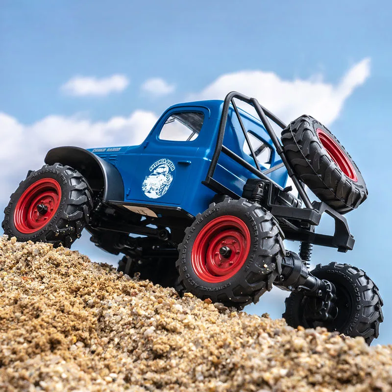 FMS FCX24S Power Wagon RC crawler climbing a sandy hill.